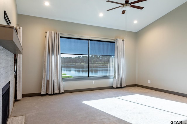 unfurnished room featuring baseboards, ceiling fan, carpet, a fireplace, and recessed lighting