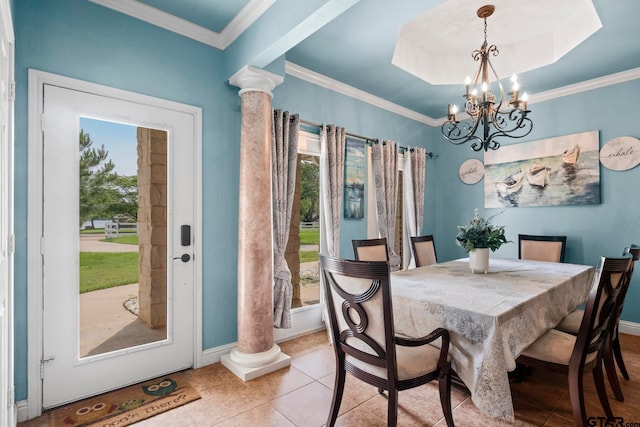 tiled dining area featuring ornate columns, a notable chandelier, ornamental molding, and a tray ceiling