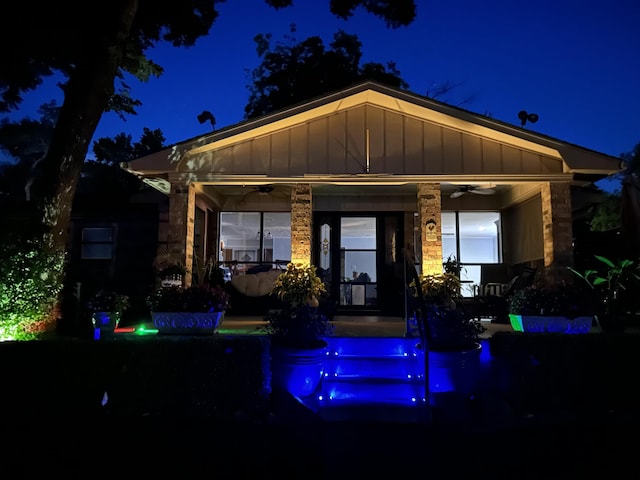 14227 Melody Ln, Malakoff, TX 75148 - back of house at twilight with a ceiling fan, an outdoor pool, and board and batten siding