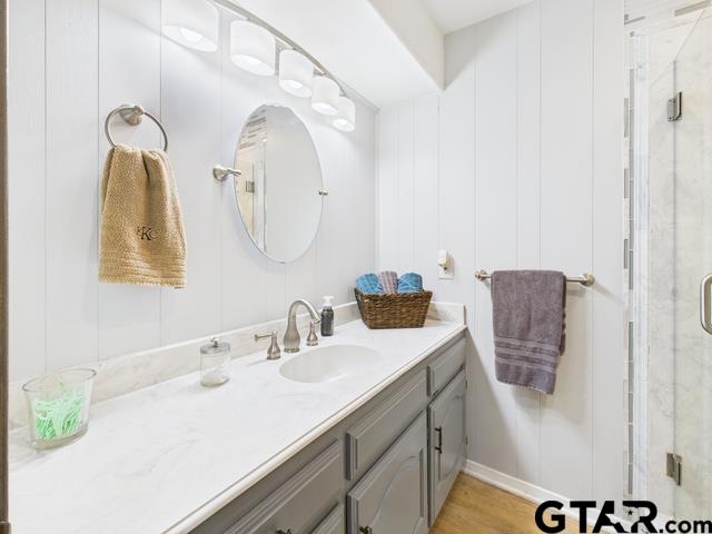 14227 Melody Ln, Malakoff, TX 75148 - bathroom with vanity, a shower stall, and wood finished floors