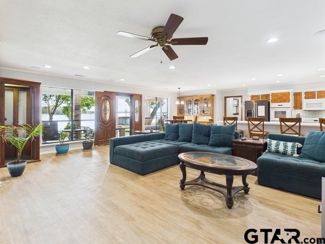 14227 Melody Ln, Malakoff, TX 75148 - living room featuring ornamental molding, recessed lighting, light wood-type flooring, and a ceiling fan