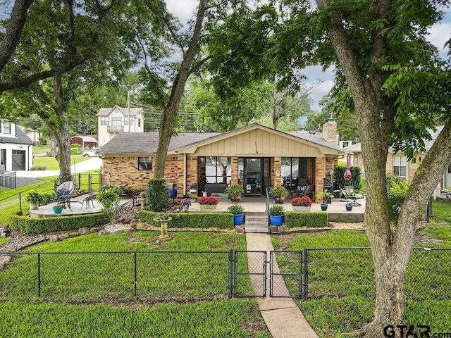 14227 Melody Ln, Malakoff, TX 75148 - bungalow-style house featuring a gate, a patio area, brick siding, and a chimney