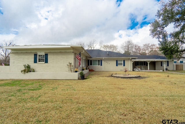 back of property featuring a lawn