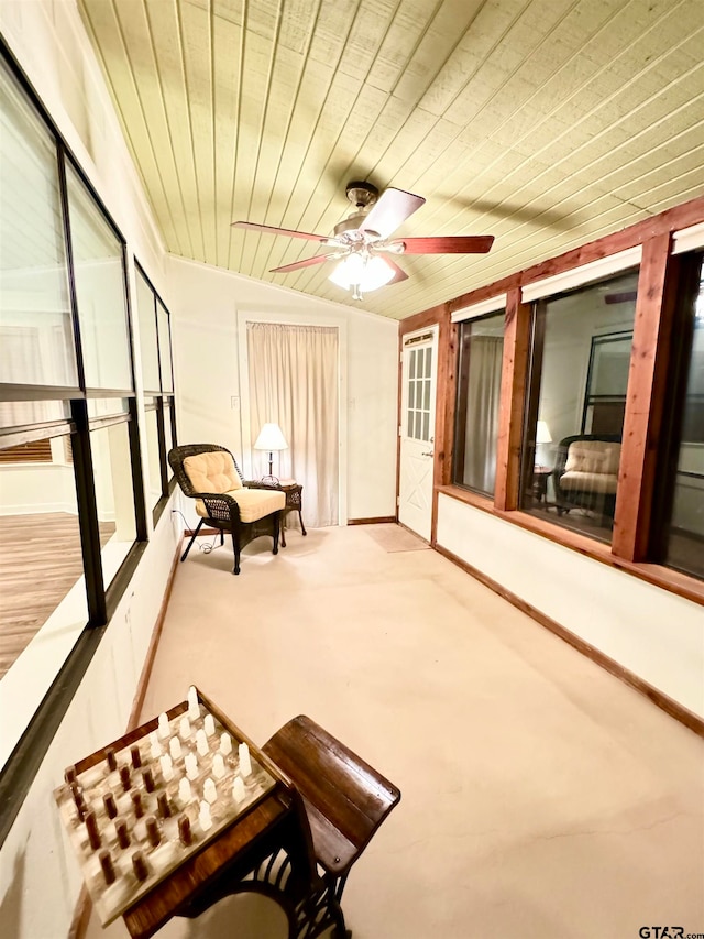 sunroom / solarium featuring ceiling fan, wooden ceiling, and vaulted ceiling