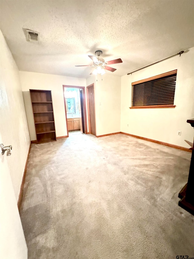 unfurnished room with carpet, a textured ceiling, and ceiling fan