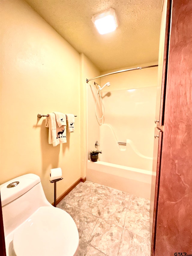 bathroom with tile patterned flooring, bathtub / shower combination, a textured ceiling, and toilet