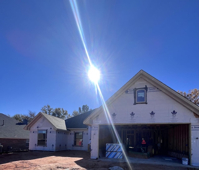 unfinished property featuring a garage