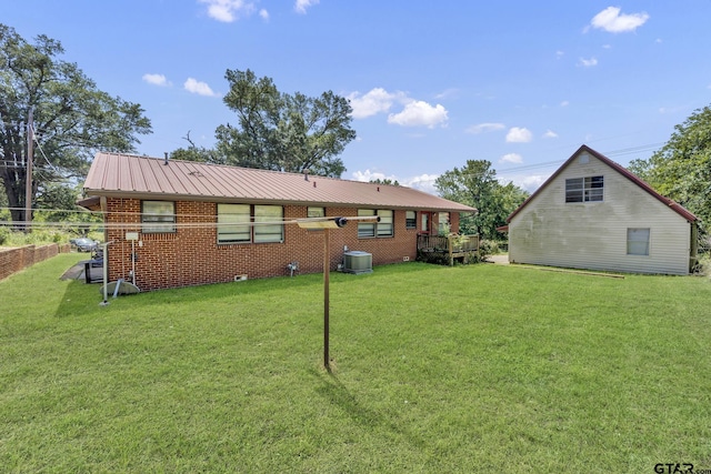 109 Maxine St, Mineola, TX 75773 - back of property featuring a yard, central AC, and brick siding