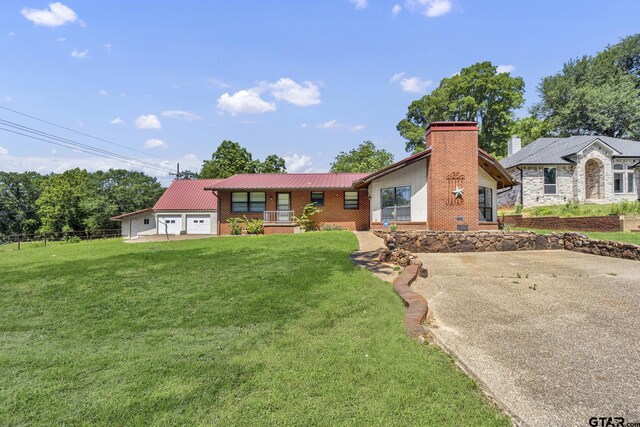 109 Maxine St, Mineola, TX 75773 - view of front facade with brick siding, a front lawn, a chimney, and metal roof