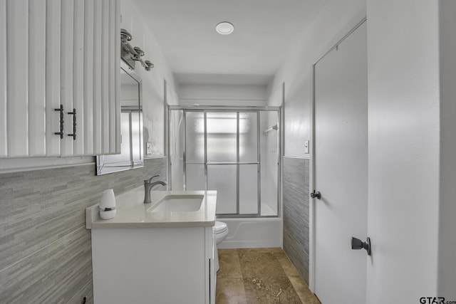 109 Maxine St, Mineola, TX 75773 - full bath with vanity, toilet, tile walls, and shower / bath combination with glass door