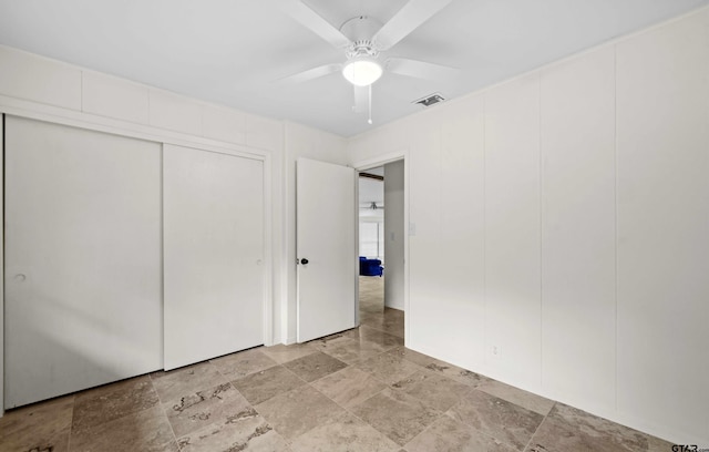 109 Maxine St, Mineola, TX 75773 - unfurnished bedroom featuring a closet, a ceiling fan, and light stone finish flooring