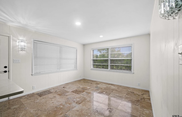 109 Maxine St, Mineola, TX 75773 - spare room with stone tile floors, baseboards, recessed lighting, and wood walls