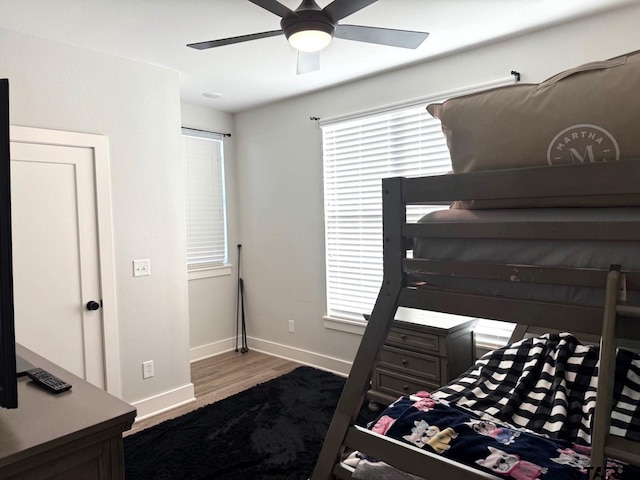 bedroom with ceiling fan and dark hardwood / wood-style floors