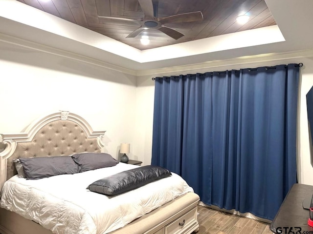 bedroom featuring a tray ceiling, wood ceiling, light hardwood / wood-style flooring, and ceiling fan