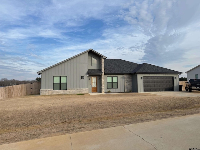 view of front of house with a garage and a front lawn