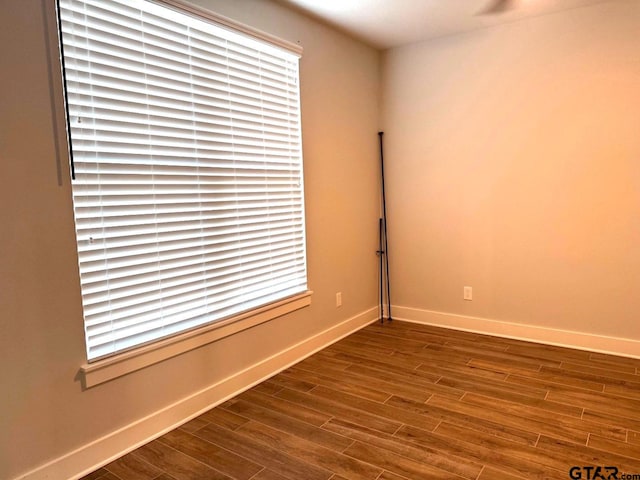 unfurnished room with wood-type flooring