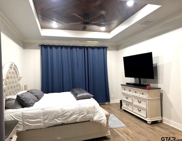 bedroom featuring hardwood / wood-style flooring, wooden ceiling, a raised ceiling, and ceiling fan