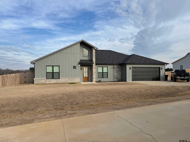 view of front of house with a garage and a front yard