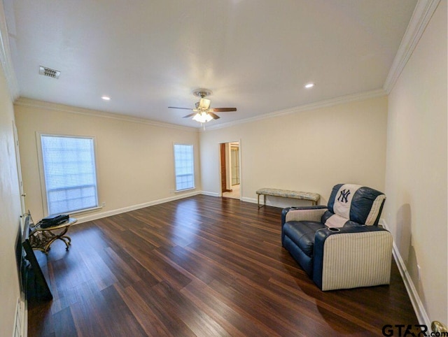 living area with dark hardwood / wood-style floors, crown molding, and ceiling fan