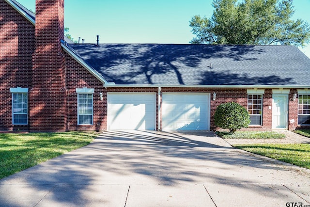 view of front facade with a front lawn and a garage