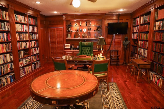 office area featuring ornamental molding, dark hardwood / wood-style flooring, a textured ceiling, and built in shelves