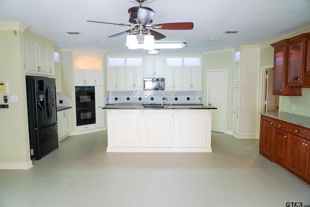 kitchen featuring a center island with sink, black appliances, ceiling fan, crown molding, and backsplash