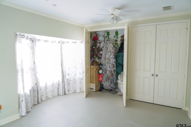 bedroom with ornamental molding and ceiling fan