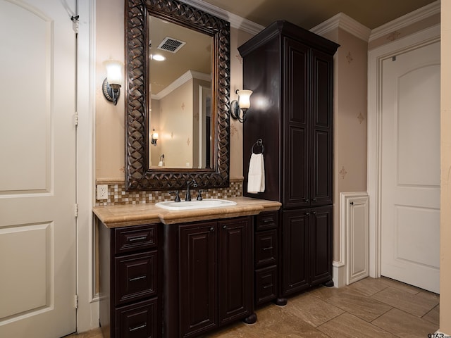 bathroom with tasteful backsplash, vanity, and ornamental molding