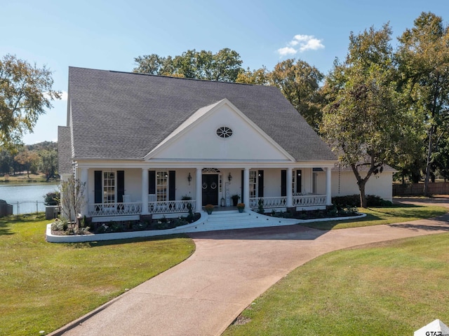 neoclassical / greek revival house with a porch and a front yard