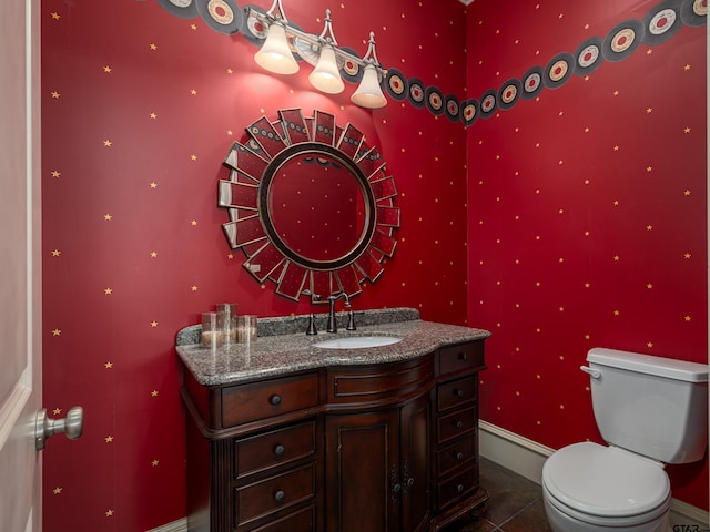 bathroom featuring toilet, vanity, and tile patterned floors