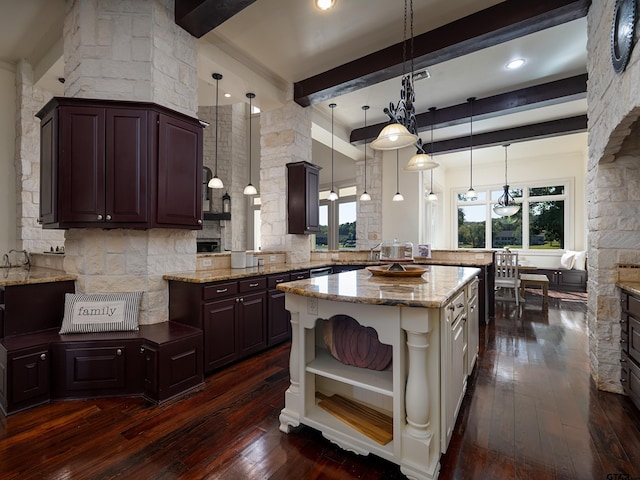 kitchen with beamed ceiling, decorative light fixtures, dark hardwood / wood-style floors, and a center island