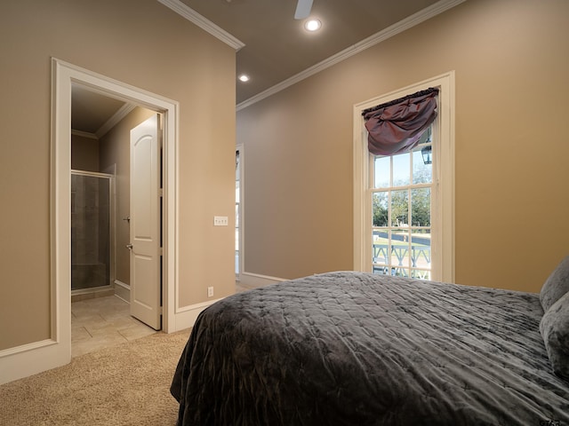 carpeted bedroom with ornamental molding and ensuite bath