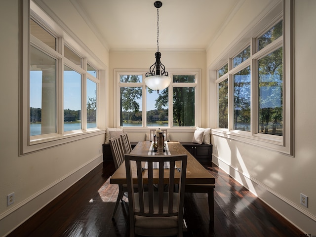 sunroom / solarium with plenty of natural light and a water view