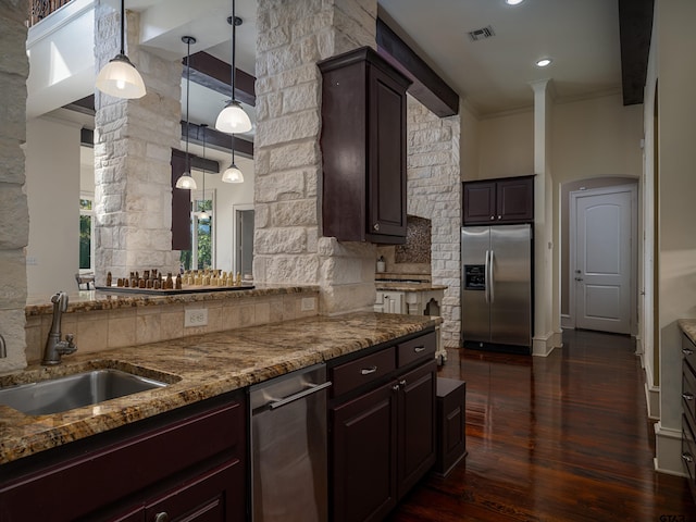 kitchen with dark brown cabinets, stainless steel fridge, sink, and dark hardwood / wood-style flooring