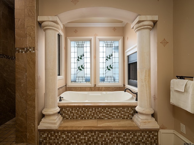 bathroom with ornamental molding and tiled tub