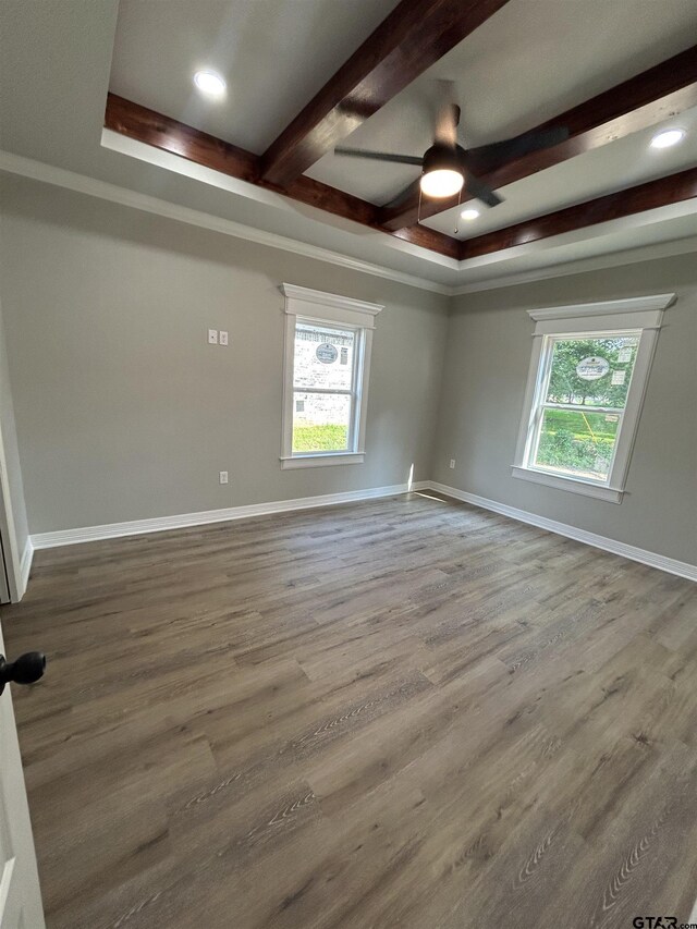300RODENAVENU 300 Roden Ave, Gladewater, TX 75647 - empty room with ceiling fan, healthy amount of natural light, beamed ceiling, wood finished floors, and baseboards