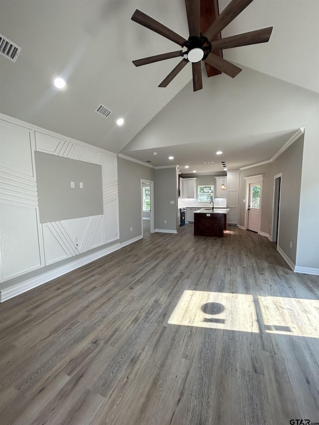 300RODENAVENU 300 Roden Ave, Gladewater, TX 75647 - unfurnished living room featuring a ceiling fan, recessed lighting, baseboards, wood finished floors, and ornamental molding