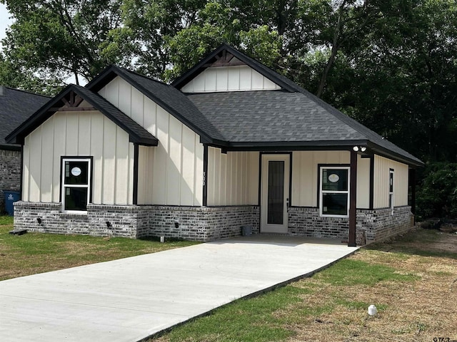 300RODENAVENU 300 Roden Ave, Gladewater, TX 75647 - view of front facade with roof with shingles, brick siding, board and batten siding, and driveway