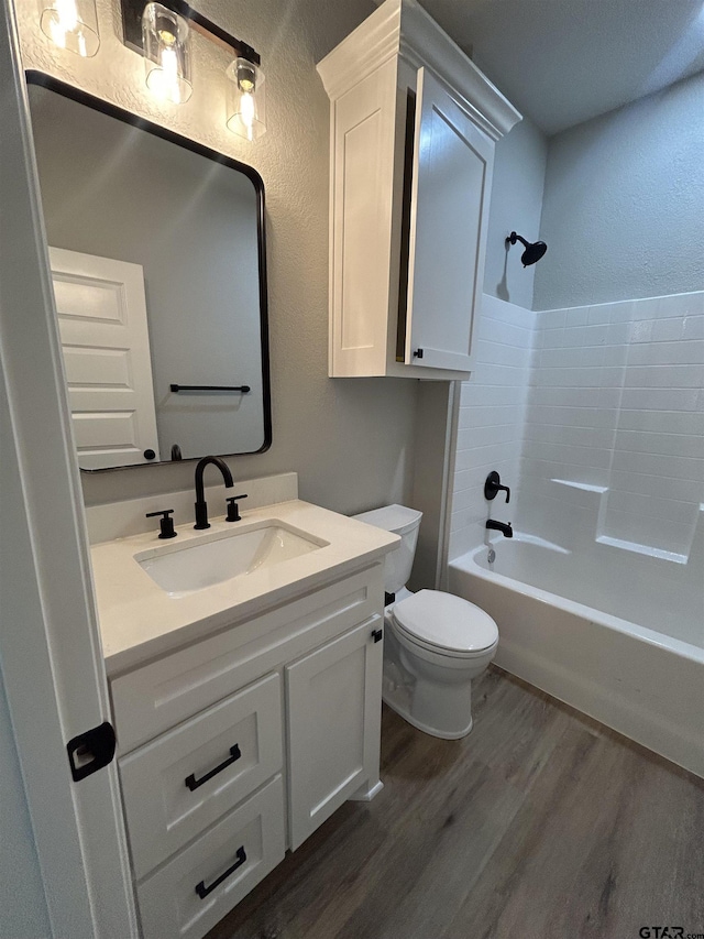 300RODENAVENU 300 Roden Ave, Gladewater, TX 75647 - bathroom featuring wood finished floors, toilet, vanity, a textured wall, and shower / bath combination