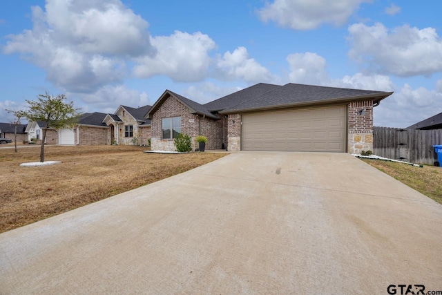 view of front of property featuring a garage and a front yard