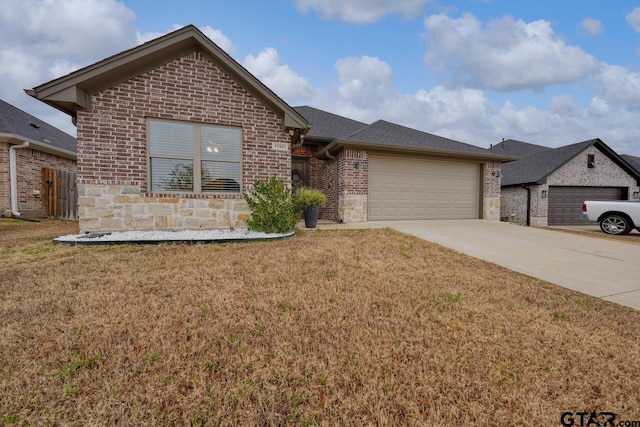 view of front of property with a garage and a front lawn