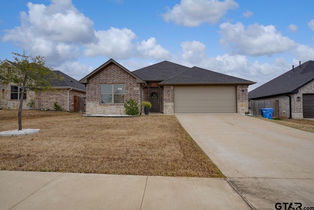 view of front of property featuring a garage and a front lawn