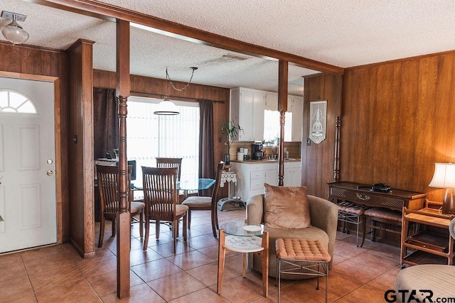 8105 Jewell Ln, Tyler, TX 75703 - interior space with a textured ceiling, wooden walls, and light tile patterned floors