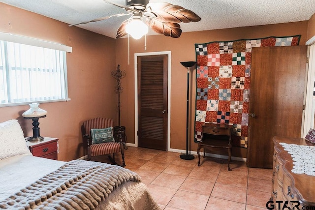 8105 Jewell Ln, Tyler, TX 75703 - bedroom with a ceiling fan, light tile patterned flooring, and a textured ceiling