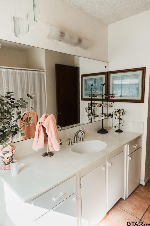 8105 Jewell Ln, Tyler, TX 75703 - full bathroom with tile patterned floors, vanity, and a textured ceiling