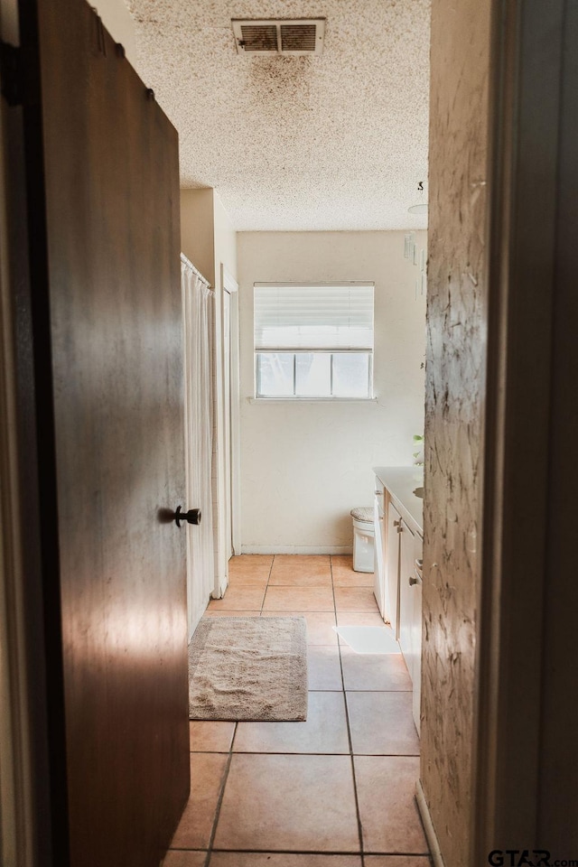 8105 Jewell Ln, Tyler, TX 75703 - full bathroom featuring visible vents, tile patterned floors, vanity, and a textured ceiling