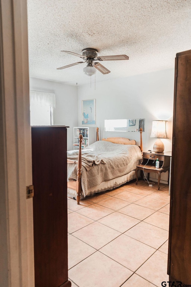8105 Jewell Ln, Tyler, TX 75703 - bedroom featuring a textured ceiling, light tile patterned flooring, and a ceiling fan