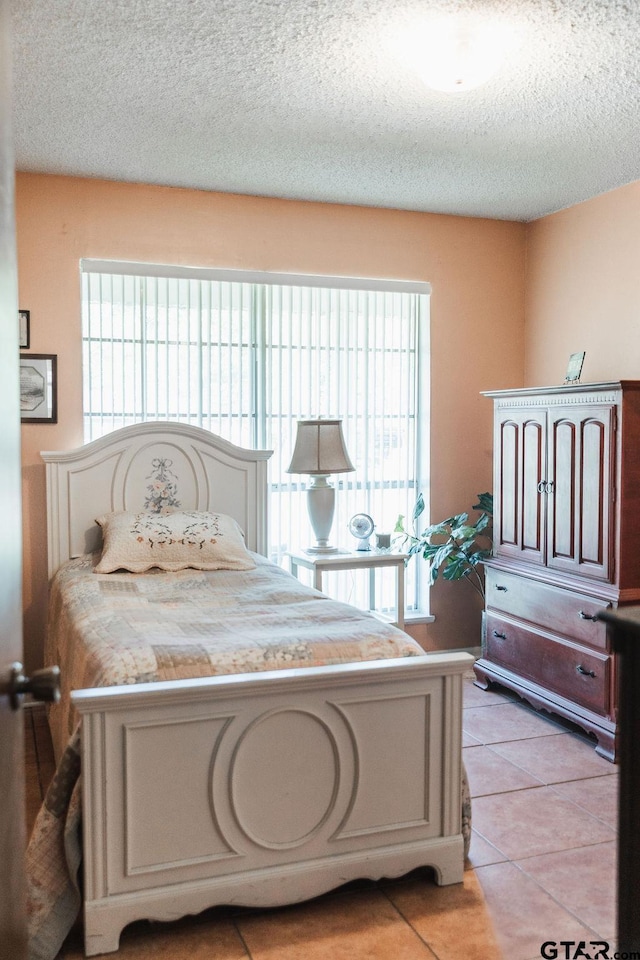 8105 Jewell Ln, Tyler, TX 75703 - bedroom featuring a textured ceiling and light tile patterned floors