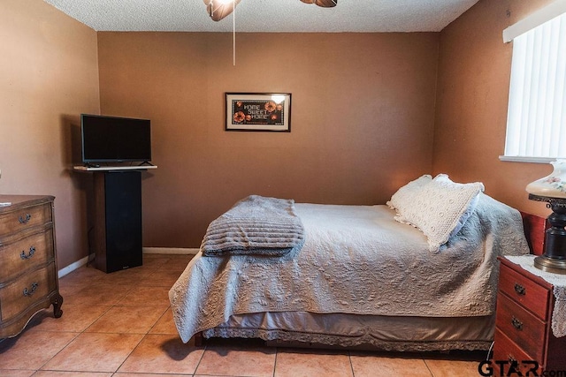 8105 Jewell Ln, Tyler, TX 75703 - tiled bedroom with a textured ceiling, baseboards, and ceiling fan