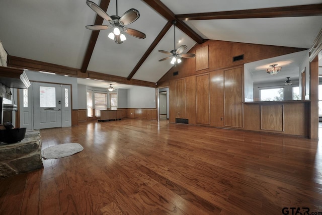 unfurnished living room with high vaulted ceiling, wood finished floors, visible vents, a ceiling fan, and beam ceiling